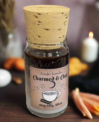 Bottle of 'Charmed & Co.' candle with cork lid on a textured surface