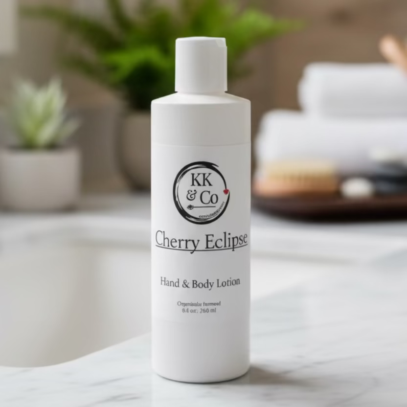 White bottle of KK & Co Cherry Eclipse Hand & Body Lotion on a wooden surface