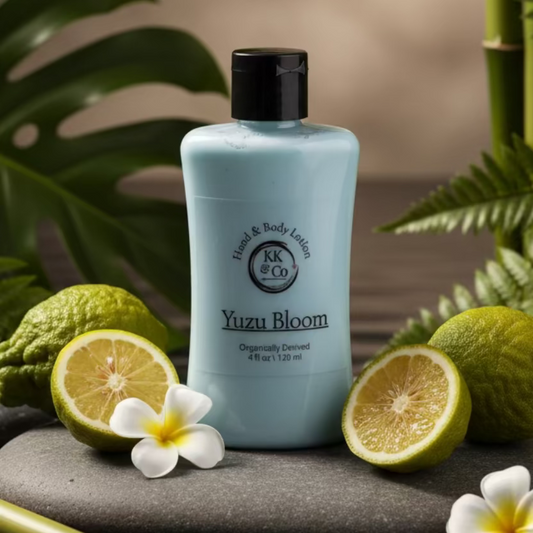 Bottle of Yuzu Bloom lotion by KK & Co on a wooden surface